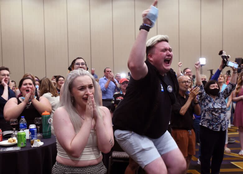 Abortion supporters Alie Utley and Joe Moyer (R) react to the failed constitutional amendment proposal at the Kansas Constitutional Freedom Primary Election Watch Party in Overland Park, Kansas on August 2, 2022. - Voters in the traditionally conservative state of Kansas voted Tuesday to maintain the right to abortion, in the first election on the flashpoint issue since the Supreme Court overturned Roe v. Wade in June, US media reported. In a significant win for the pro-access side of the US abortion debate, Kansans rejected an amendment that would have scrapped language in the state constitution guaranteeing the right to the procedure and could have paved the way for stricter regulations or a ban. (Photo by DAVE KAUP / AFP) (Photo by DAVE KAUP/AFP via Getty Images)