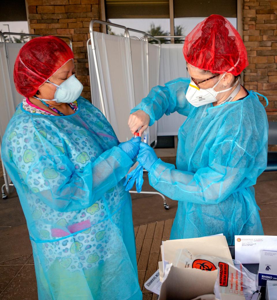 Leslie Battice and Brittany Mills prepare to administer COVID-19 tests during an employee testing event at the Absentee Shawnee Tribe's Little Axe Health Center in Norman in August. The tribe announced Friday that staffing shortages have impacted its ability to provide all the health care services it normally provides.