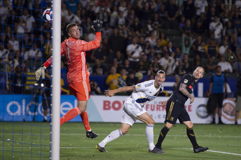 Jul 19, 2019; Carson, CA, USA; LA Galaxy forward Zlatan Ibrahimovic (9) heads the ball for a goal while Los Angeles FC defender Jordan Harvey (2) defends during the second half  at Dignity Health Sports Park. Mandatory Credit: Kelvin Kuo-USA TODAY Sports