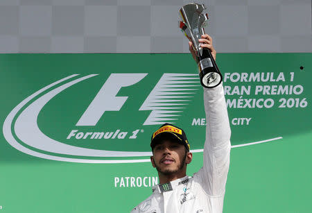 Formula One - F1 - Mexican F1 Grand Prix - Mexico City, Mexico - 30/10/16 - Mercedes' driver Lewis Hamilton of Britain celebrates after winning the race. REUTERS/Henry Romero