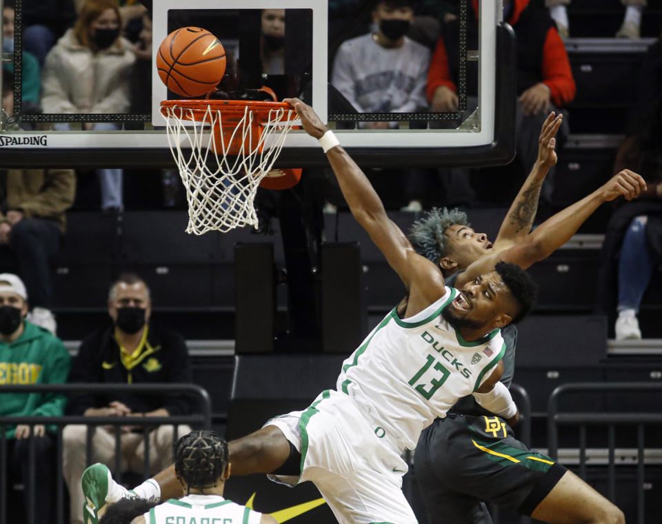 Oregon forward Quincy Guerrier (13), attempts a basket against Baylor in the first half during an NCAA college basketball game in Eugene, Ore., Saturday, Dec. 18, 2021. (AP Photo/Thomas Boyd)