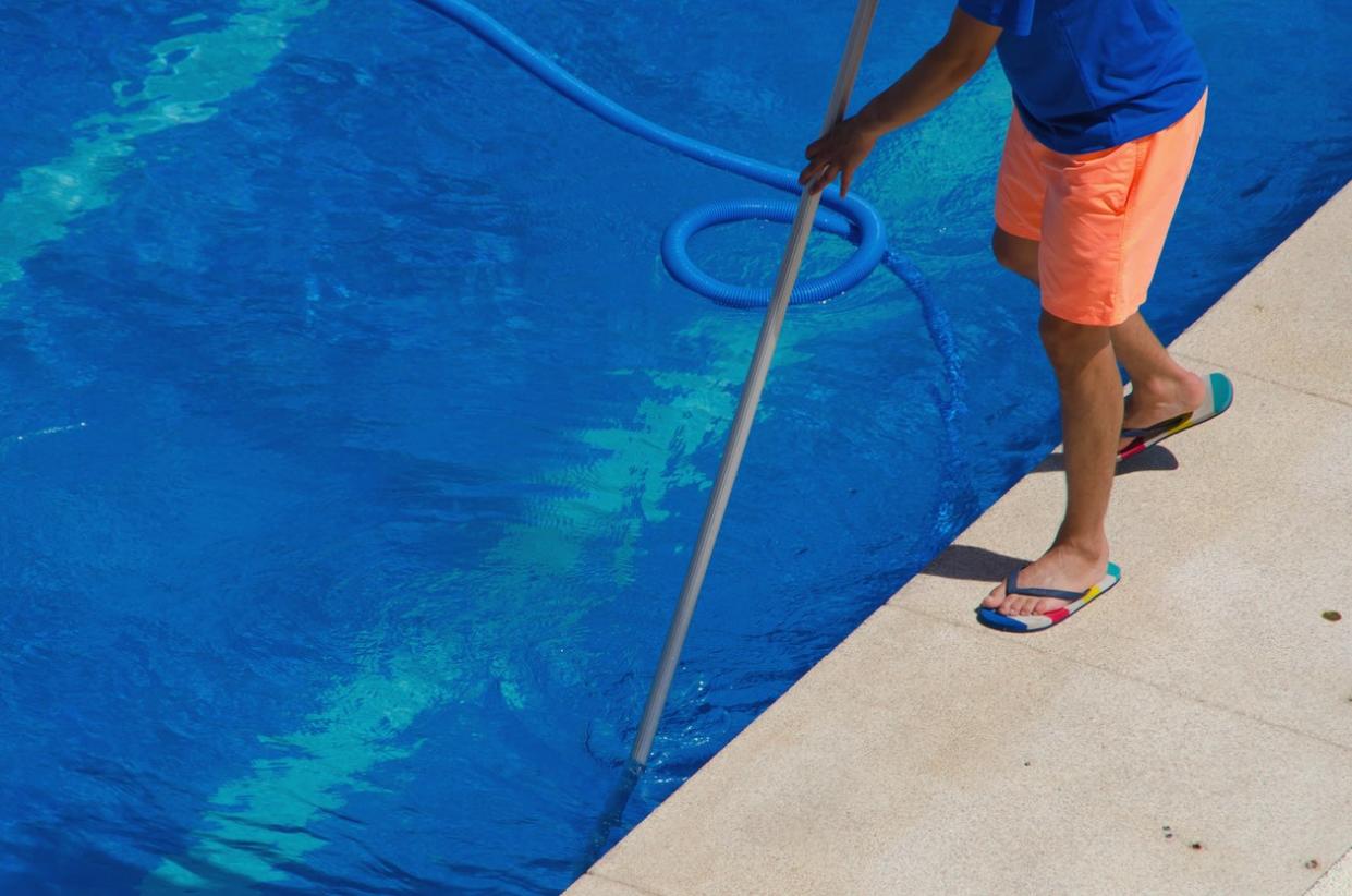 Cleaning A Swimming Pool with Vacuums.