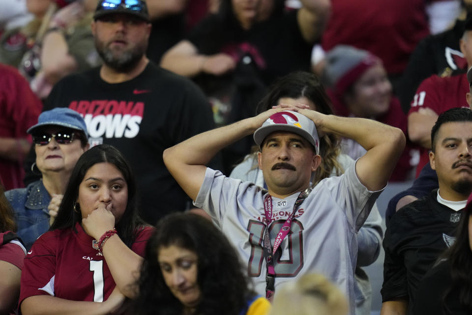 Arizona Cardinals fans watch during the second half of an NFL football game against the Los Angeles Chargers, Sunday, Nov. 27, 2022, in Glendale, Ariz. The Chargers defeated the Cardinals 25-24. (AP Photo/Ross D. Franklin)