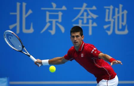 Novak Djokovic of Serbia returns a shot to Guillermo Garcia-Lopez of Spain during their men's singles match at the China Open tennis tournament in Beijing September 30, 2014. REUTERS/Petar Kujundzic