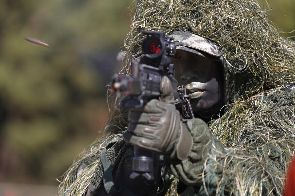 A South Korean marine fires a gun during their regular drill on Yeonpyeong Island, South Korea Thursday, Nov. 1, 2018. The U.S. and South Korea are reviewing whether they will conduct large-scale military exercises next year and will decide before December. South Korean Defense Minister Jeong Kyeong-doo told reporters Wednesday at the Pentagon that if more exercises are suspended the two countries will conduct other training to mitigate the lapse. He says the review will be done by Nov. 15. (Jeon Heon-kyun/Pool Photo via AP)