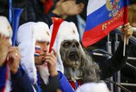 A Russian fan wearing a mask watches the women's preliminary round ice hockey game between Germany and Sweden during the 2014 Sochi Winter Olympics February 11, 2014. REUTERS/Shamil Zhumatov (RUSSIA - Tags: SPORT OLYMPICS)