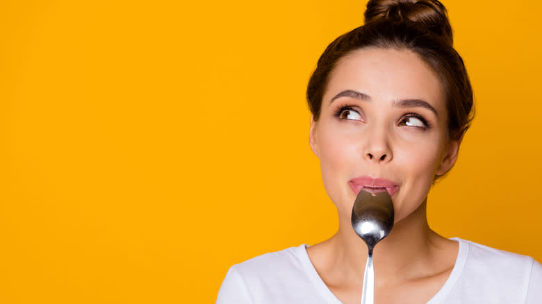 Girl licking spoon