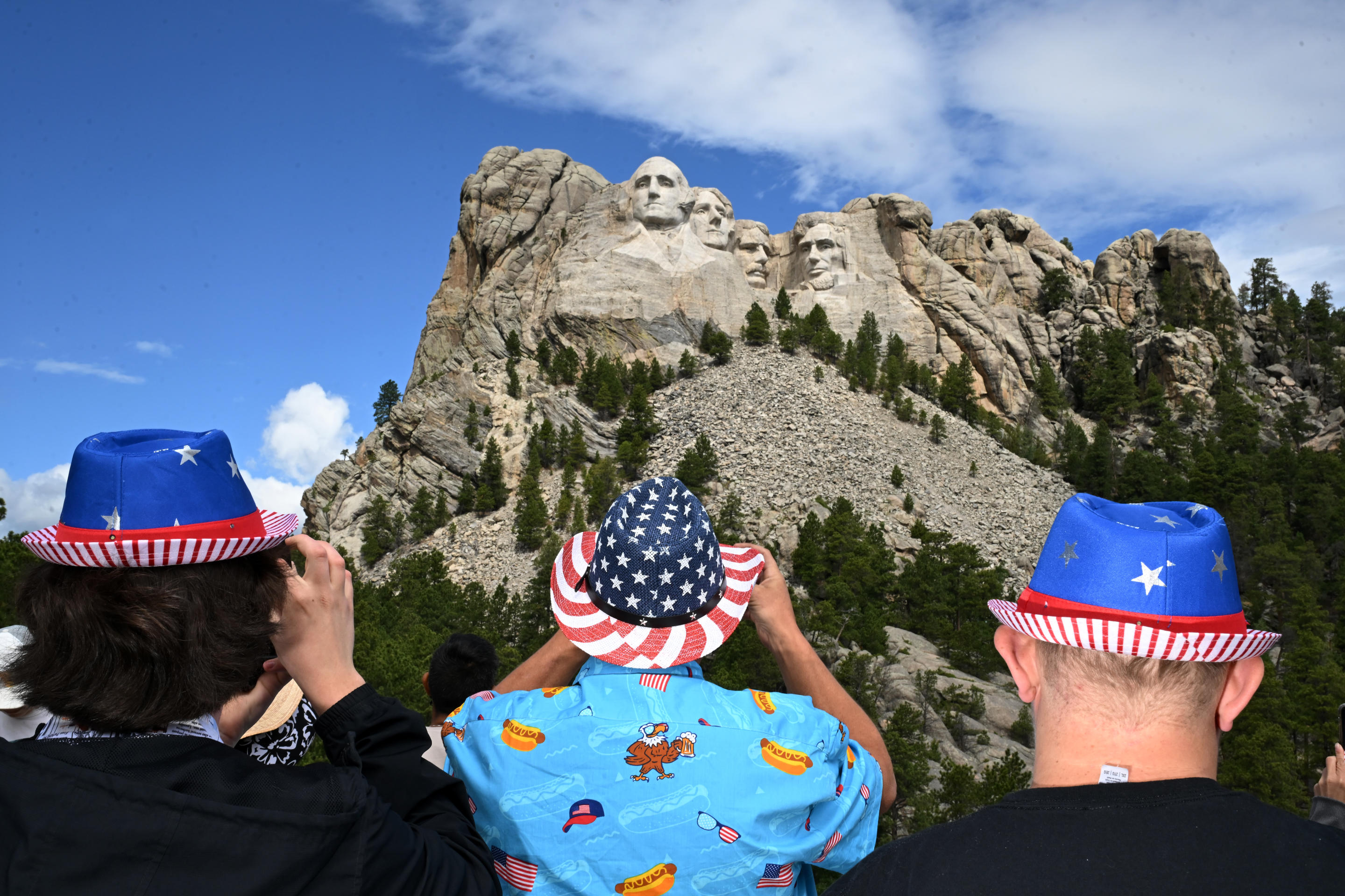 Visitors at Mount Rushmore National Memorial in Keystone, S.D., wear patriotic hats to celebrate the Fourth of July