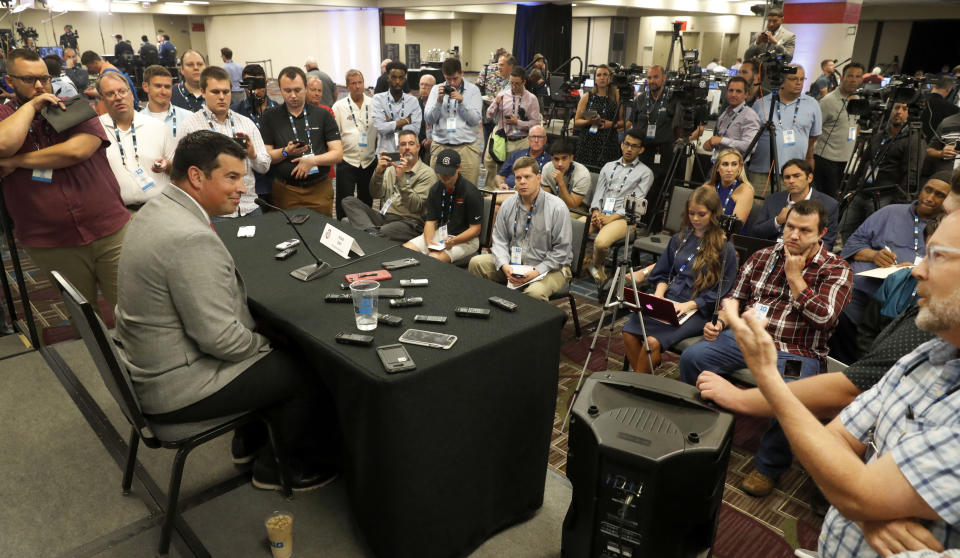 Ohio State head coach Ryan Day, left, talks to reporters during the Big Ten Conference NCAA college football media days Thursday, July 18, 2019, in Chicago. (AP Photo/Charles Rex Arbogast)