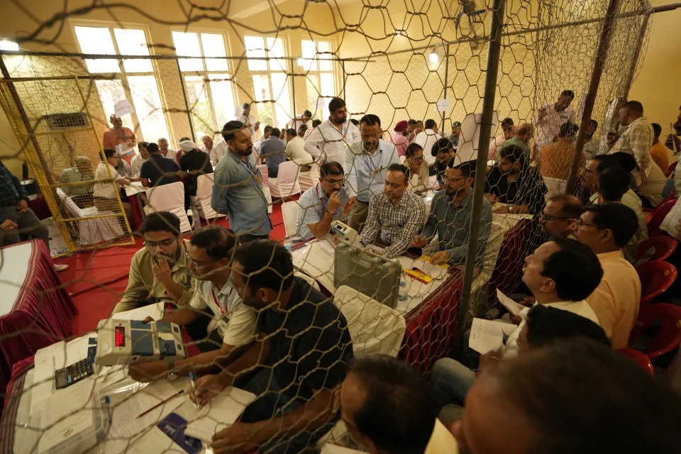 Election officers count votes for the recent election at a counting center in Jammu, India, Tuesday, Oct. 8, 2024. (AP Photo/Channi Anand)