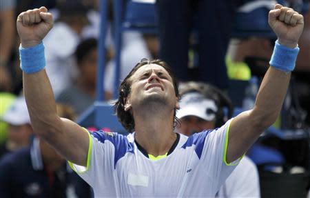 David Ferrer of Spain celebrates after defeating Mikhail Kukushkin of Kazakhstan at the U.S. Open tennis championships in New York August 31, 2013. REUTERS/Eduardo Munoz