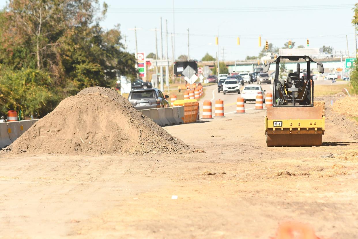 Traffic moves down N.C. 133 in Leland as construction continues on a new lane along the roadway Wednesday Nov. 1, 2023.