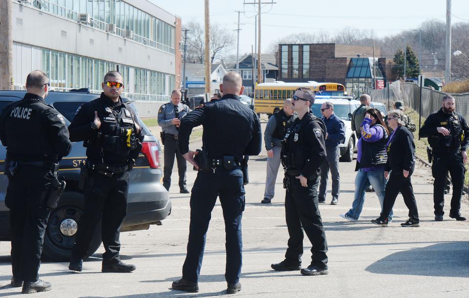 Erie Bureau of Police officers gather near Erie High School after a student was shot and injured there in Erie on April 5.