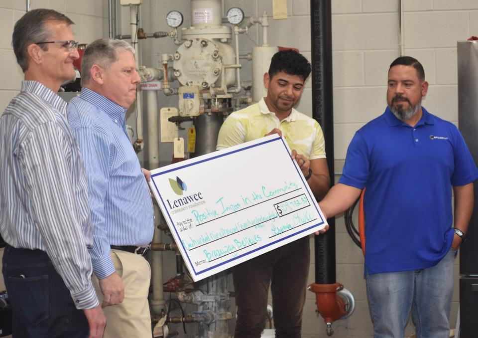From left, Mike Adams, Brazeway executive vice president for product and manufacturing engineering; Terry Sheehan, Brazeway president and CEO; Jose Salazar, corporate human resources generalist and a two-year team member with Brazeway; and Dan Solis, product development engineering technician at Brazeway, display a check from the Lenawee Community Foundation noting the amount of funds the Brazeway Believes campaign raised in 2022. The total amount of $109,792.32 will be managed by the community foundation for "Positive Impact in the Community" as written on the check.