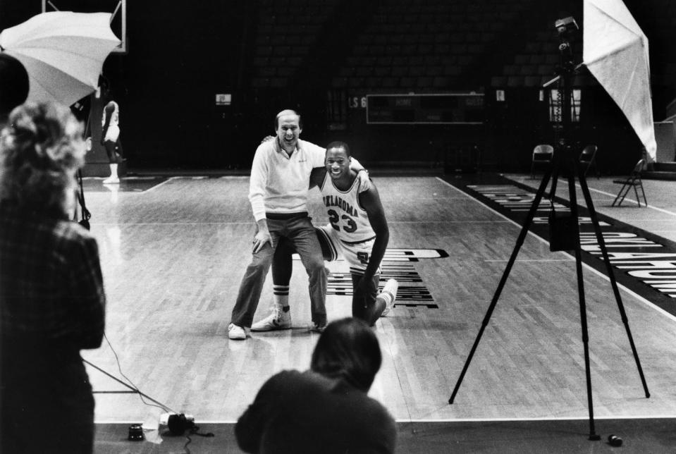 Wayman Tisdale poses with Billy Tubbs as Janice Higgins with the Norman Transcript takes their photo during medis day, Nov. 11, 1984, at Lloyd Noble Arena in Norman, Okla.  By Doug Hoke/The Oklahoman