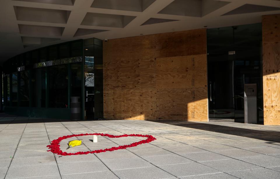 A petal of roses in the shape of a heart decorates the entrance of Old National Bank Tuesday morning after Monday's mass shooting there Monday morning, killing five people and injured nine, including two Louisville Metro Police officers in downtown Louisville, Ky.  April 11, 2023