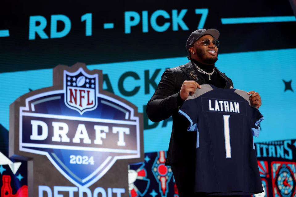 JC Latham celebrates after being selected seventh overall by the Tennessee Titans during the first round of the 2024 NFL Draft at Campus Martius Park and Hart Plaza on April 25, 2024 in Detroit, Michigan. / Credit: Getty Images