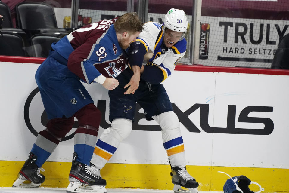 Colorado Avalanche left wing Gabriel Landeskog, left, fights with St. Louis Blues center Brayden Schenn in the first period of Game 1 of an NHL hockey Stanley Cup first-round playoff series Monday, May 17, 2021, in Denver. (AP Photo/David Zalubowski)