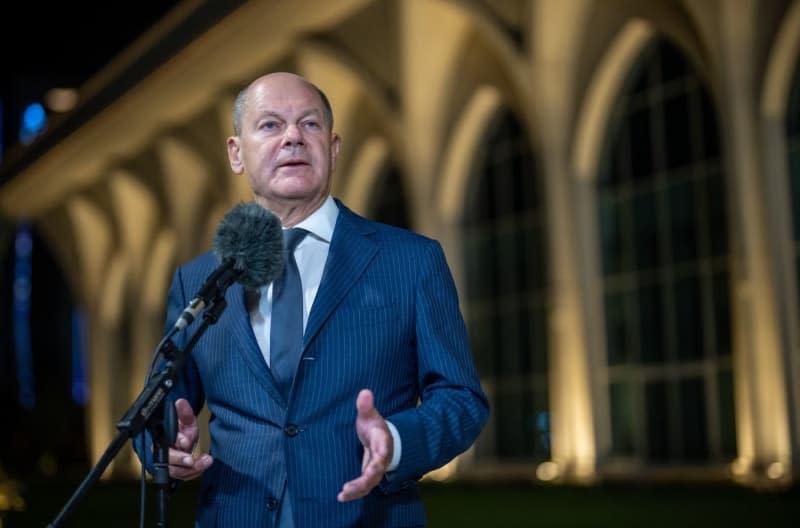 Germany's Chancellor Olaf Scholz speaks during a press statement after signing a migration agreement with Uzbekistan. Michael Kappeler/dpa