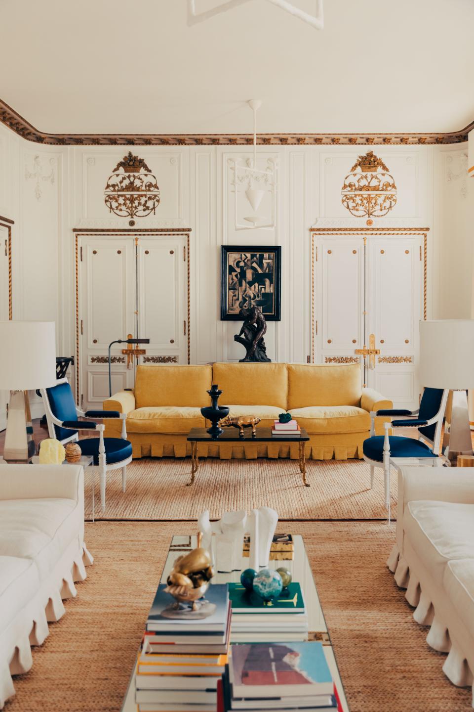 Antique and vintage furnishings decorate the living room, which is crowned by an Alexandre Logé chandelier. Robert Marc painting.