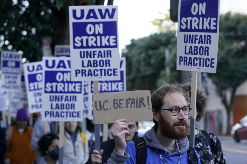 People take part in a protest outside of University of California San Francisco medical offices in San Francisco, Monday, Nov. 14, 2022. Nearly 48,000 unionized academic workers at all 10 University of California campuses have walked off the job Monday. (AP Photo/Jeff Chiu)