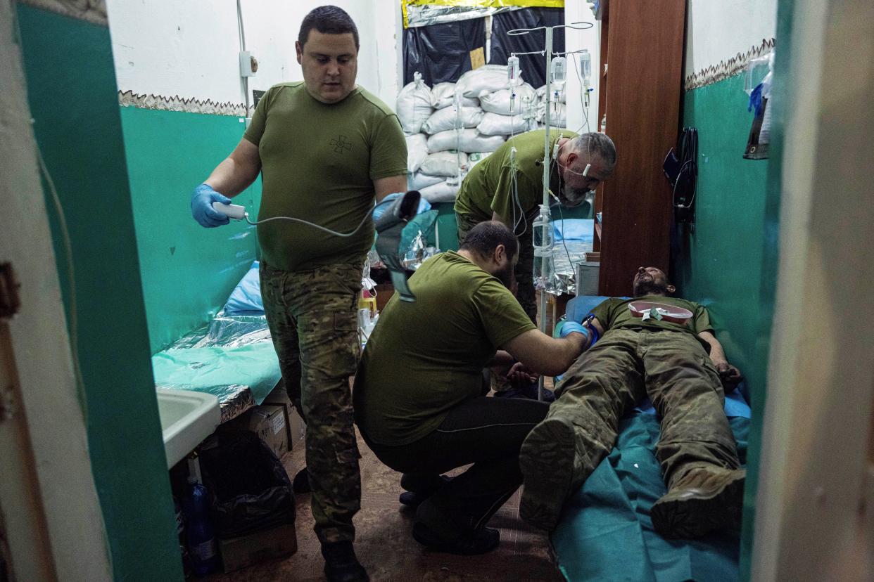 Ukrainian military medics treat a soldier with concussion in a field hospital in Donetsk region, Ukraine (AP)