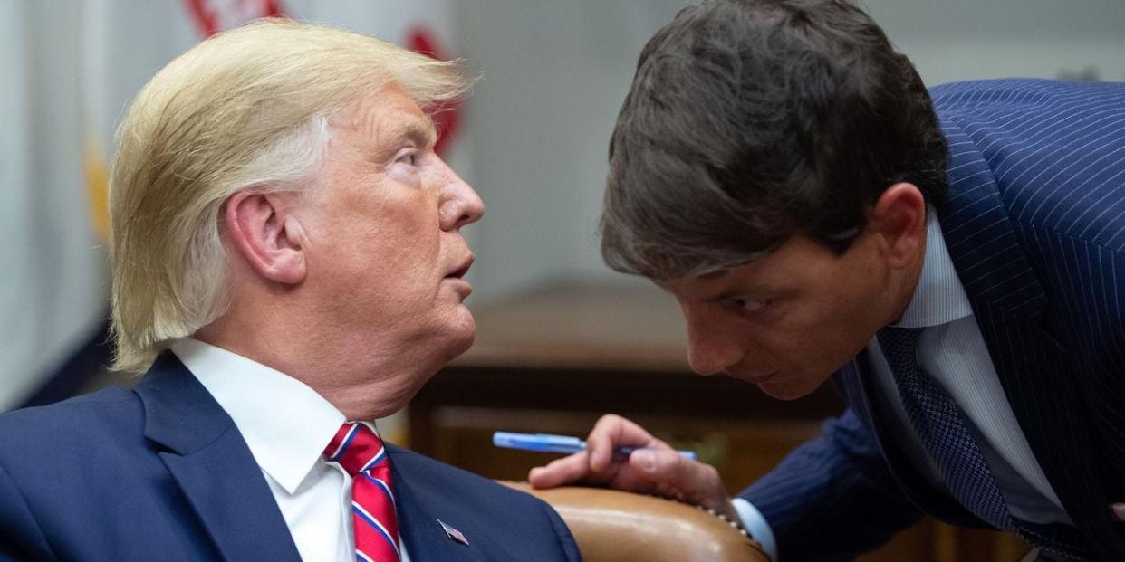 President Donald Trump speaks with Hogan Gidley (R), White House Principal Deputy Press Secretary, during a meeting on the opioid epidemic in the Roosevelt Room of the White House in Washington, DC, June 12, 2019.