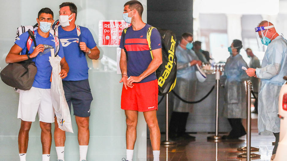 Tennis players, pictured here waiting for transport outside the Grand Hyatt Hotel in Melbourne.