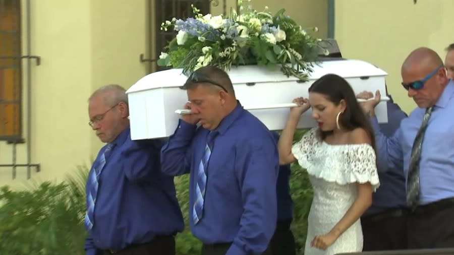 A small white casket is carried out of Holy Family Catholic Church in South Pasadena for the funeral of Aramazd Andressian Jr. (Credit: Pool)