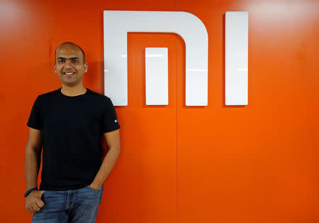 Manu Kumar Jain, Managing Director of Xiaomi India, poses next to the logo of Xiaomi after an interview with Reuters inside his office in Bengaluru, India, January 18, 2018. REUTERS/Abhishek N. Chinnappa
