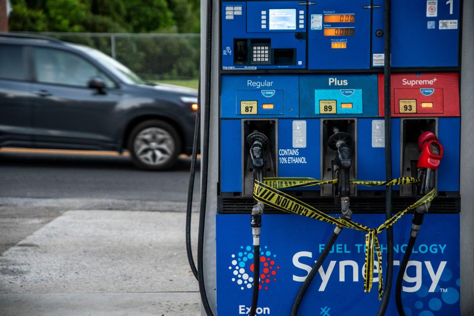 Caution tape is wrapped around fuel pumps at an Exxon Gas Station on Boonsboro Road in Lynchburg, Va., May 11, 2021. More than 1,000 gas stations in the Southeast reported running out of fuel, primarily because of what analysts say is unwarranted panic-buying among drivers, as the shutdown of a major pipeline by hackers entered its fifth day. In response, Virginia Gov. Ralph Northam declared a state of emergency.