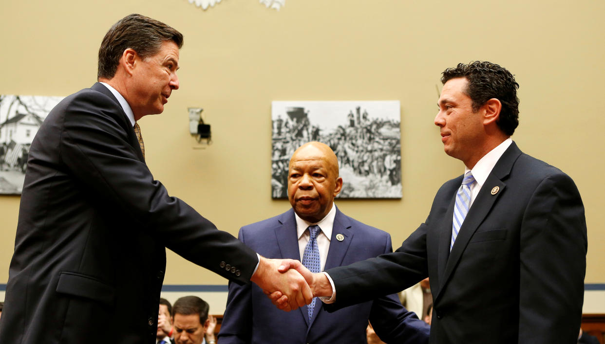 FBI Director James Comey (L) shakes hands with Chairman Jason Chaffetz (R-CA) (R) and ranking member Elijah Cummings (D-MD) (C) before testifying at a House Oversight and Government Reform Committee on the 
