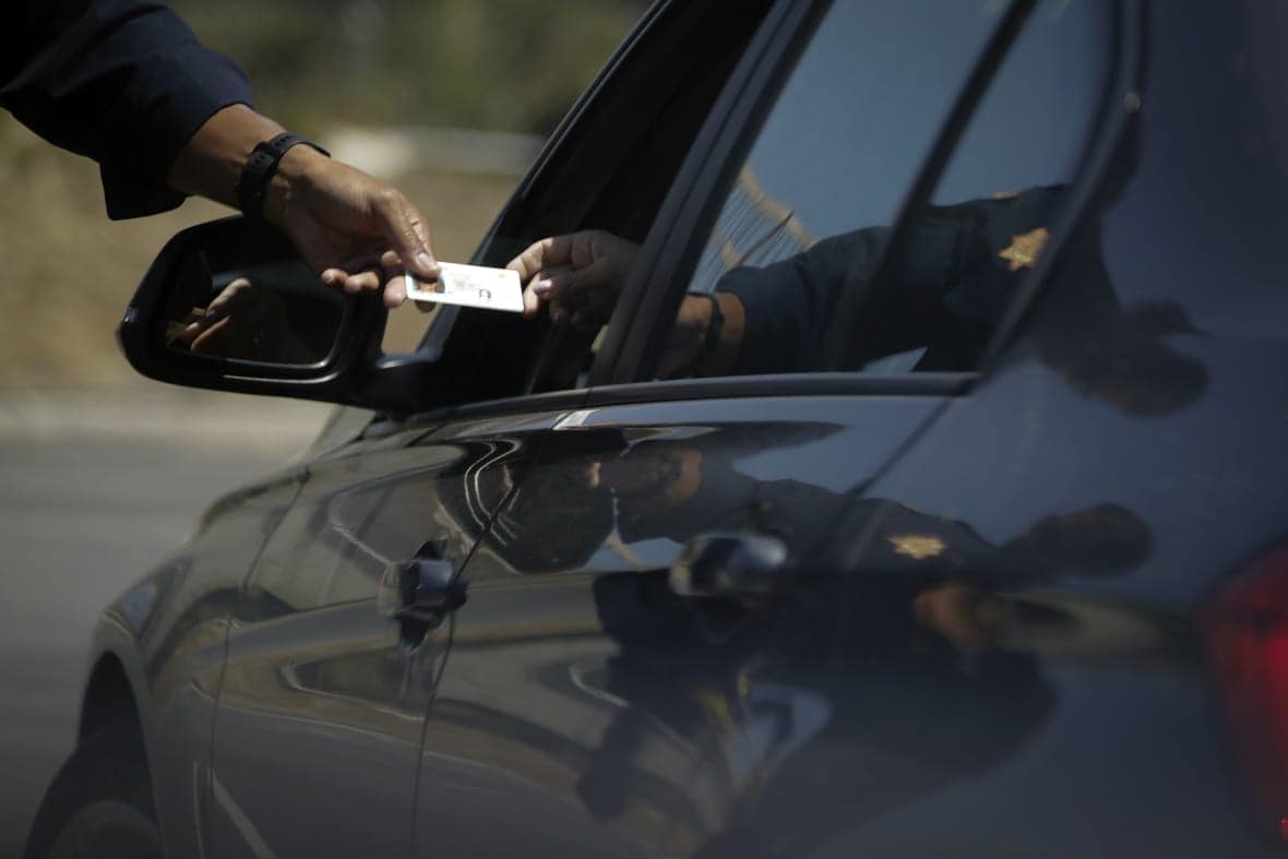 A California Highway Patrol officer stops a motorist who was suspected of speeding along Interstate 405 freeway on April 23, 2020, in Westminster, Calif. (AP Photo/Chris Carlson, File)