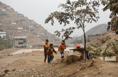 Children walk to school near Nueva Union shantytown in Villa Maria del Triunfo district of Lima, Peru, June 1, 2018. REUTERS/Mariana Bazo