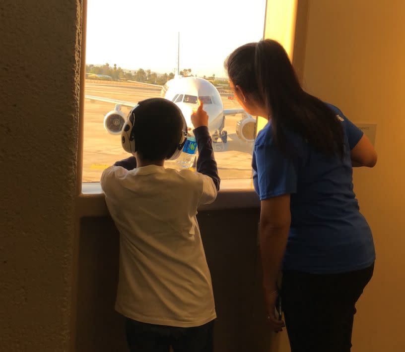 Michael and an American Airlines employee look out at the plane on the tarmac. (Photo Courtesy of Annette Martinez)