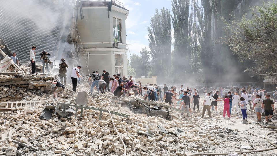 Medical staff and members of the community move rubble away from damaged areas at the hospital and search for survivors. - Gleb Garanich/Reuters