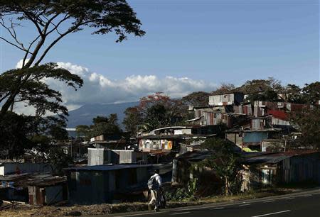 A man walks near low-income neighbourhood Triangulo de la Solidaridad, north of San Jose January 30, 2014. Costa Rica will hold general elections on February 2. REUTERS/Juan Carlos Ulate