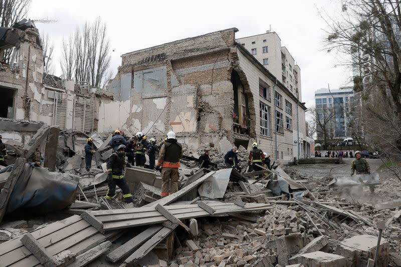 Rescuers work at the site of a building damaged by a Russian missile strike, in Kyiv