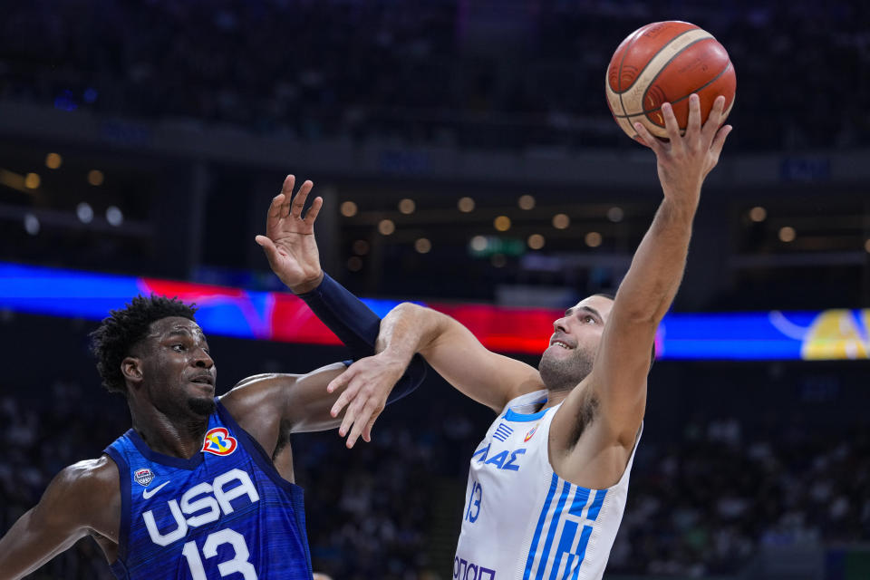 Greece forward Ioannis Papapetrou (21) shoots over U.S. forward Paolo Banchero (8) during the second half of a Basketball World Cup group C match in Manila, Philippines Monday, Aug. 28, 2023.(AP Photo/Michael Conroy)