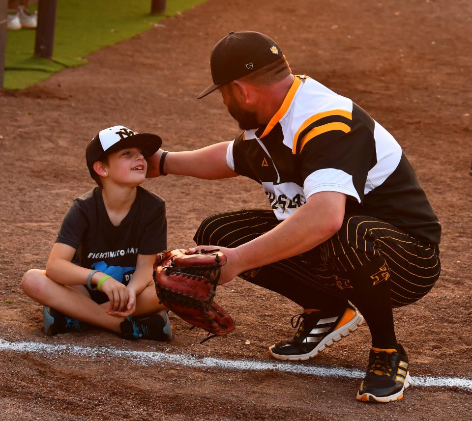 Vivian Sleeth chats with Merritt Island High baseball coach Dan Wydner near the home dugout before Friday's game against Eau Gallie High.