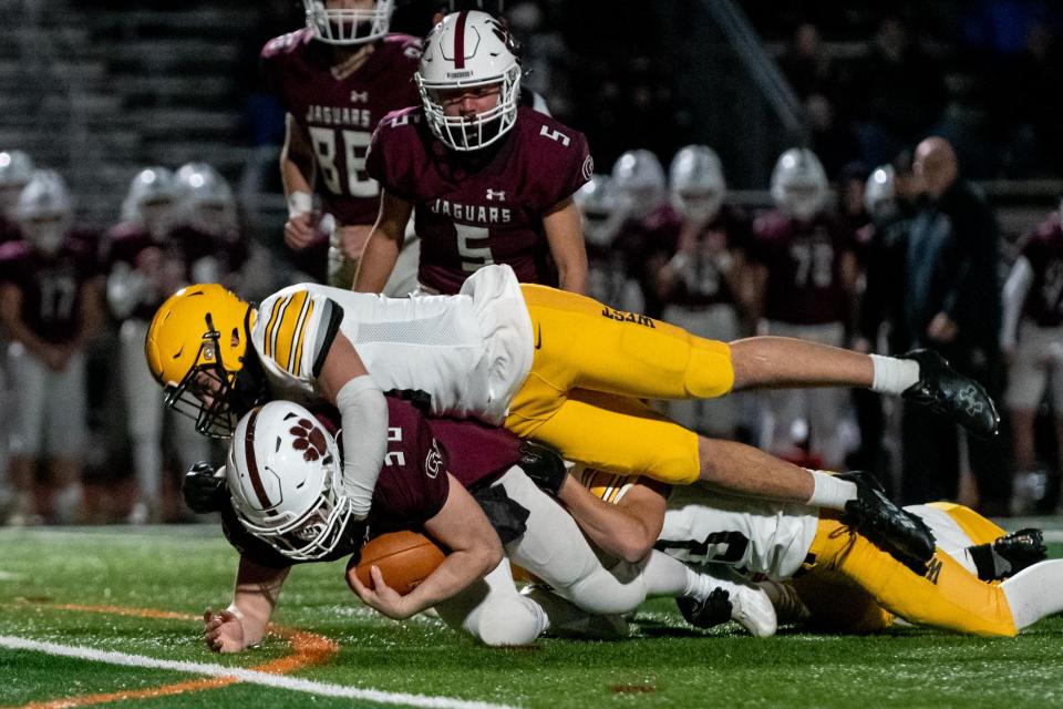 Central Bucks West senior Cooper Taylor makes a tackle during a PIAA District One playoff game against Garnet Valley from last season.