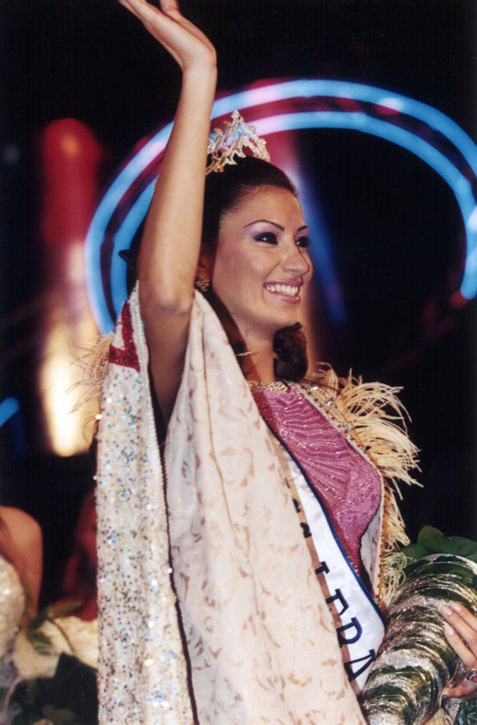 Miss Lebanon 2002 Christina Sawaya waves with a tiara on her head.