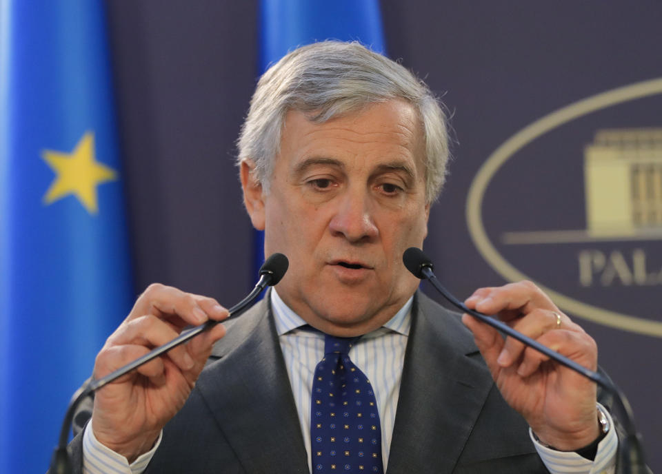 European Parliament President Antonio Tajani adjusts the microphones during joint press statements with Romanian Prime Minister Viorica Dancila at the Victoria Palace in Bucharest, Romania, Wednesday, Nov. 21, 2018. (AP Photo/Vadim Ghirda)