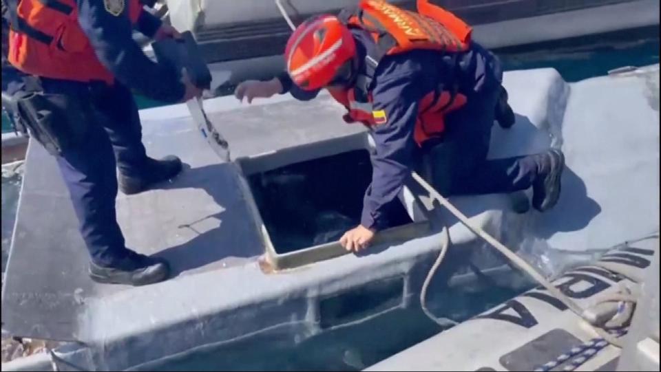 Members of the Colombian navy unload packets of cocaine from the submarine.
