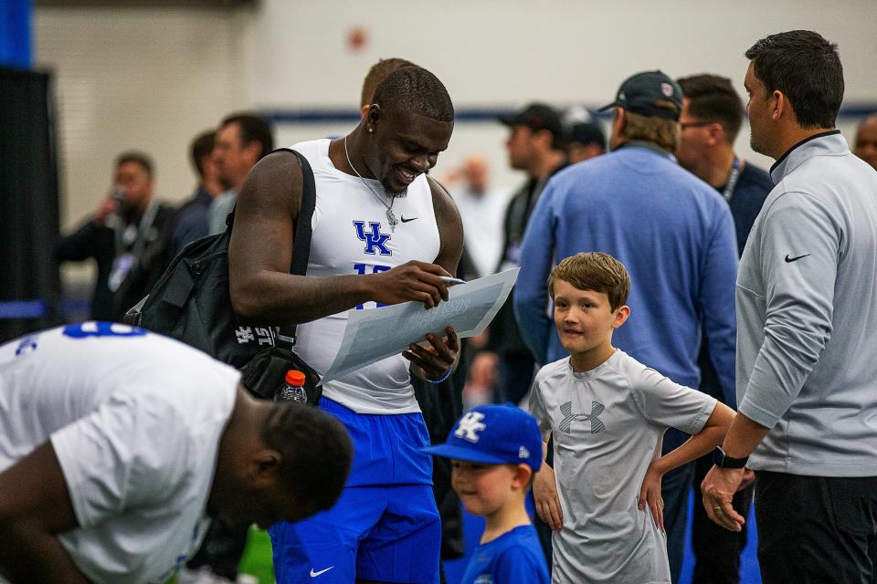 Kentucky Wildcat senior outside linebacker Jordan Wright smiled as he signed an autograph during Pro Day at the University of Kentucky's Nutter Field House in Lexington, Ky., on Friday, Mar. 24, 2023