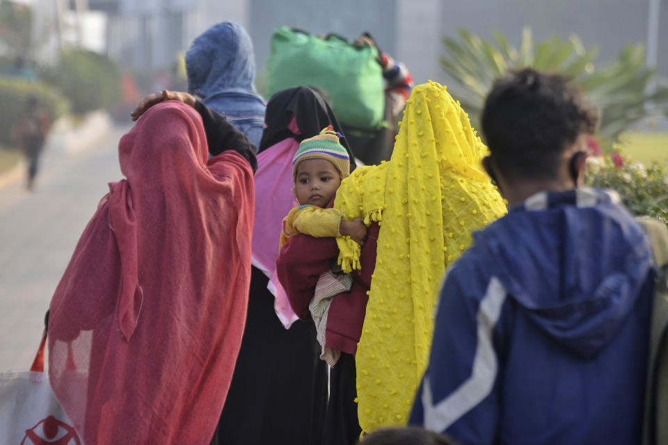 Rohingya refugees walk to board a naval vessel to be relocated to to the island of Bhasan Char, in Chattogram, Bangladesh, Saturday, Jan. 30, 2021. Authorities in Bangladesh sent a group of Rohingya refugees to a newly developed island in the Bay of Bengal on Saturday despite calls by human rights groups for a halt to the process. The government insists the relocation plan is meant to offer better living conditions while attempts to repatriate more than 1 million refugees to Myanmar would continue. (AP Photo/Azim Aunon)