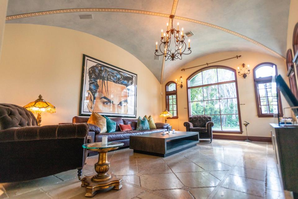 1) The living area features an original 1931 cathedral beamed ceiling and a stone fireplace.