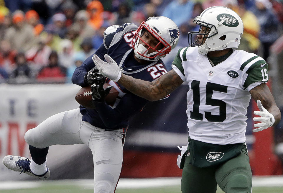 New England Patriots defensive back Eric Rowe (25) intercepts a pass intended for New York Jets wide receiver Brandon Marshall (15) during the first half of an NFL football game, Saturday, Dec. 24, 2016, in Foxborough, Mass. (AP Photo/Elise Amendola)