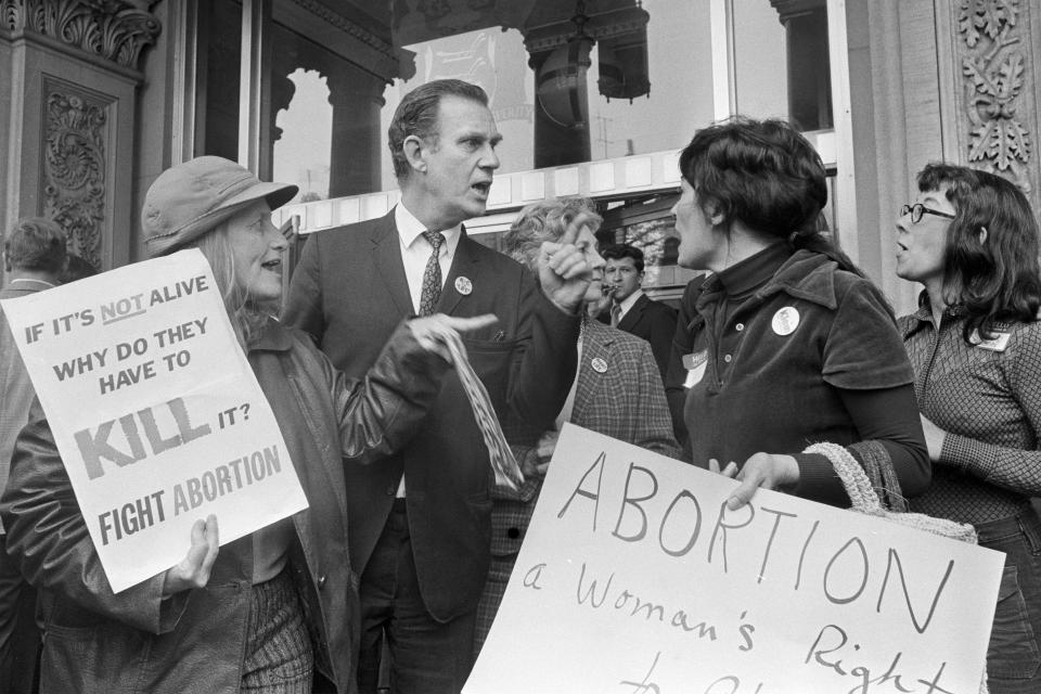 FILE - Anti-abortion and abortion-rights activists argue their viewpoints on the steps of the State House in Trenton, N.J., April 30, 1973. (AP Photo, File)