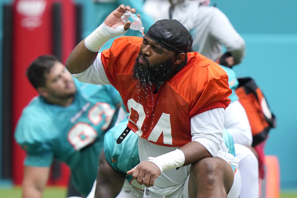 Miami Dolphins defensive tackle Christian Wilkins (94) pours water on his face during a team scrimmage at Hard Rock Stadium, Saturday, Aug. 5, 2023, in Miami Gardens, Fla. (AP Photo/Lynne Sladky)